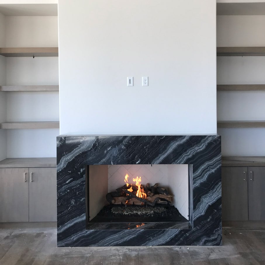 custom black marble face fireplace