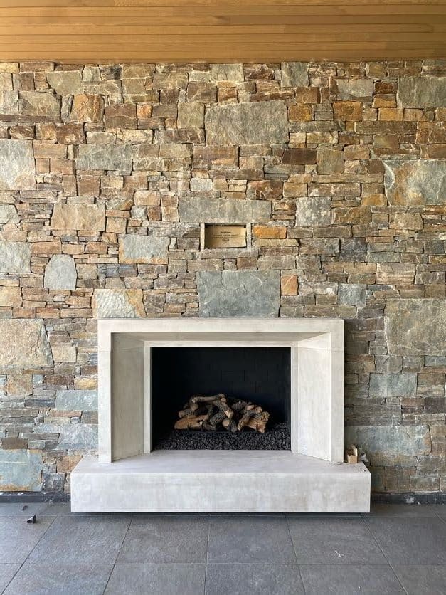 custom wood burning fireplace with rock face outdoors