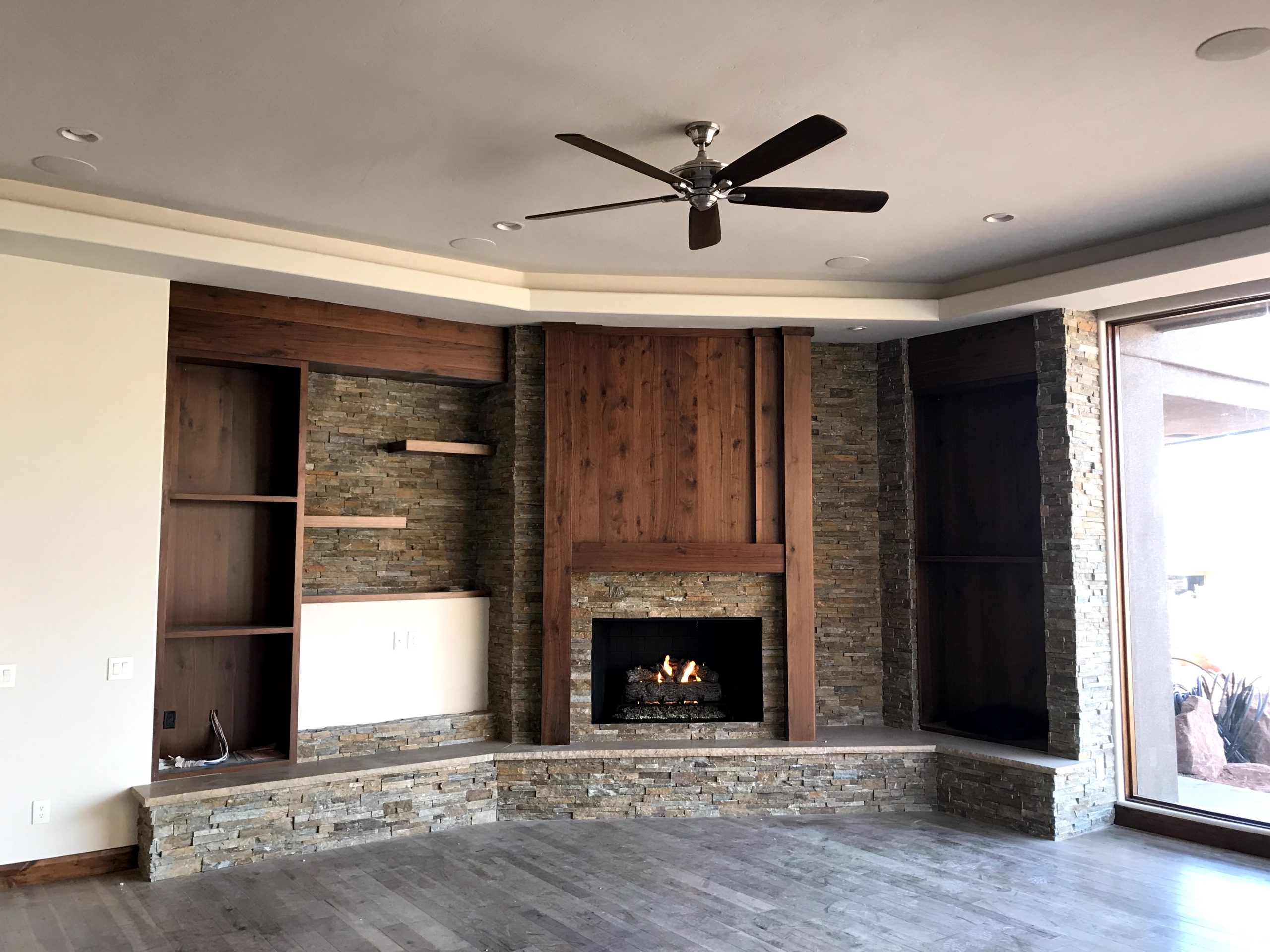 Custom corner fireplace with wood and rock face
