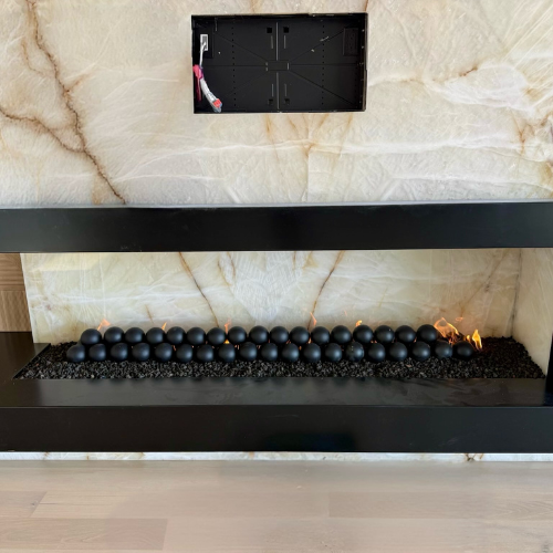 12’ wide x 24” tall sleek custom left-hand corner Mason Lite fireplace with premium lava rock + matte black fire balls for that ultra-modern look