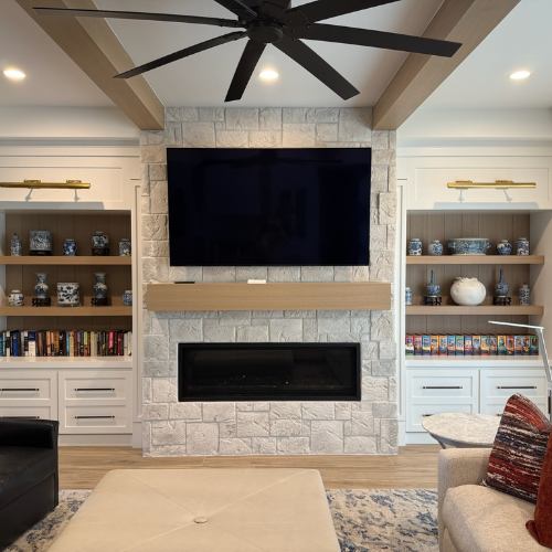 60” linear fireplace clean stone surround, custom mantel, and built-in shelving